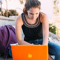 A student writing on her computer