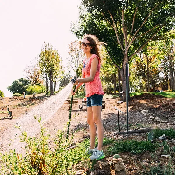 Female student watering plants